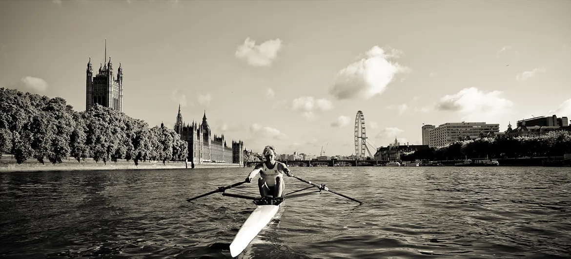 Photograph showing Josh Butler rowing outside the house of Parliament - London